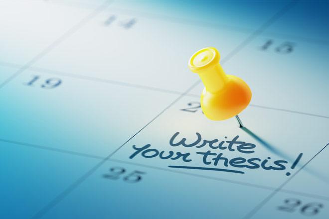 Calendar with yellow push pin on the words write your thesis!